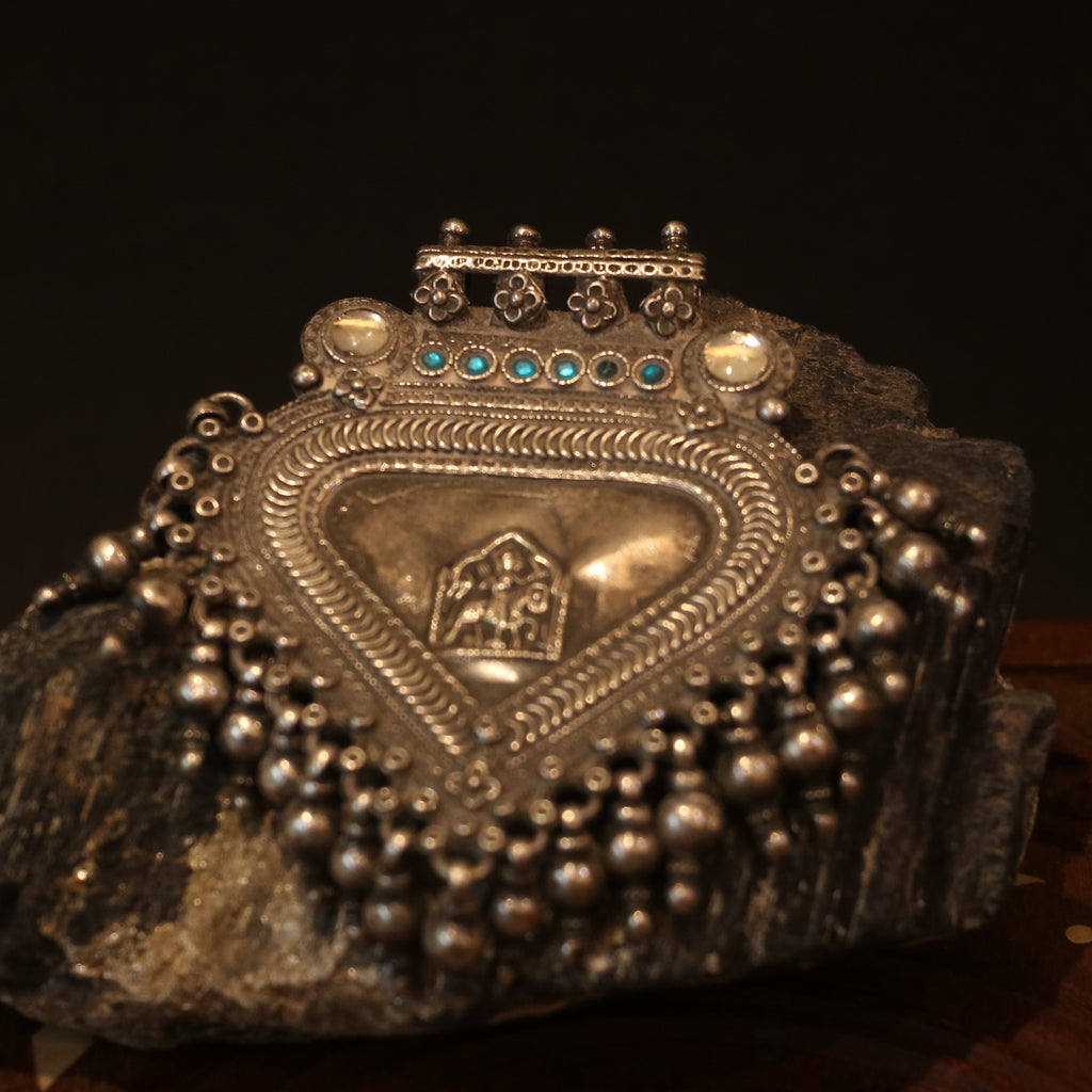 SILVER PENDANT WITH TRIBAL MOTIF , BLUE ACCENTS , AND HANGING BEEDS