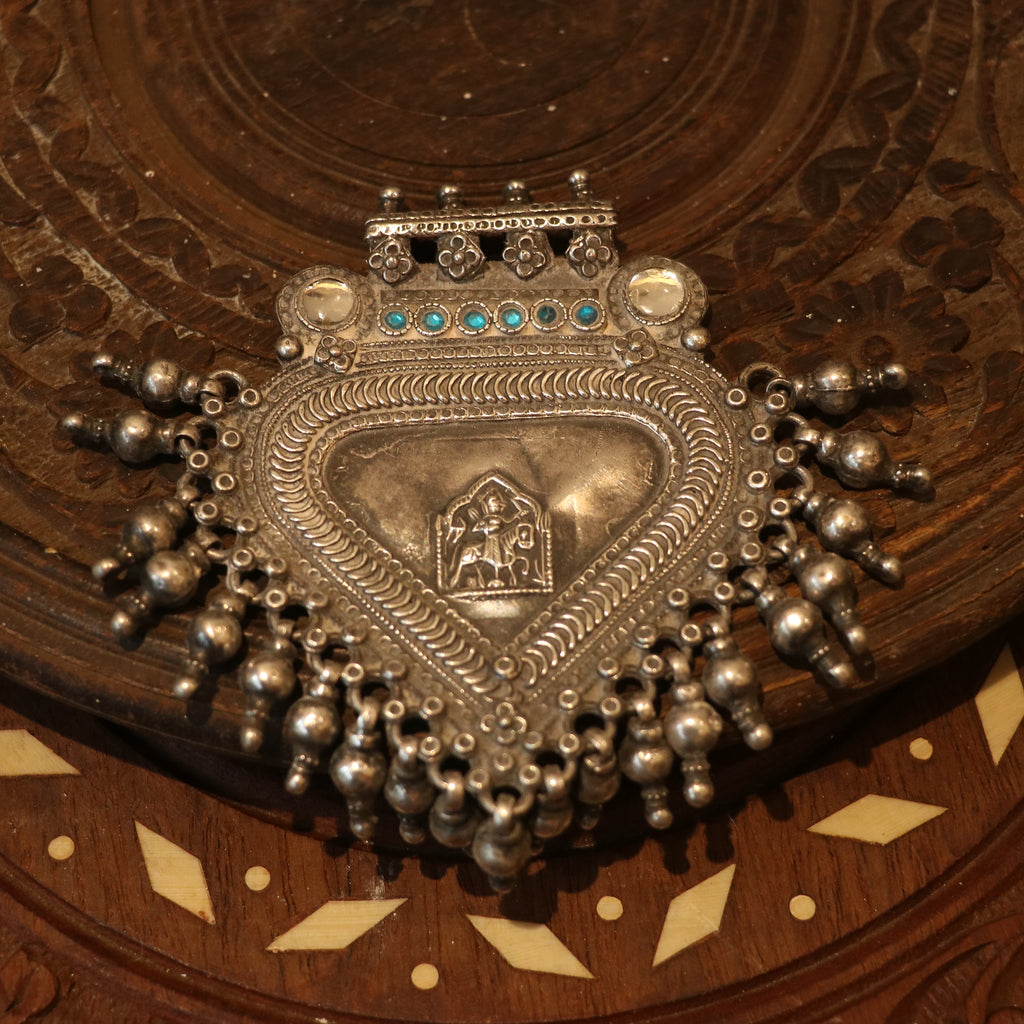 SILVER PENDANT WITH TRIBAL MOTIF , BLUE ACCENTS , AND HANGING BEEDS