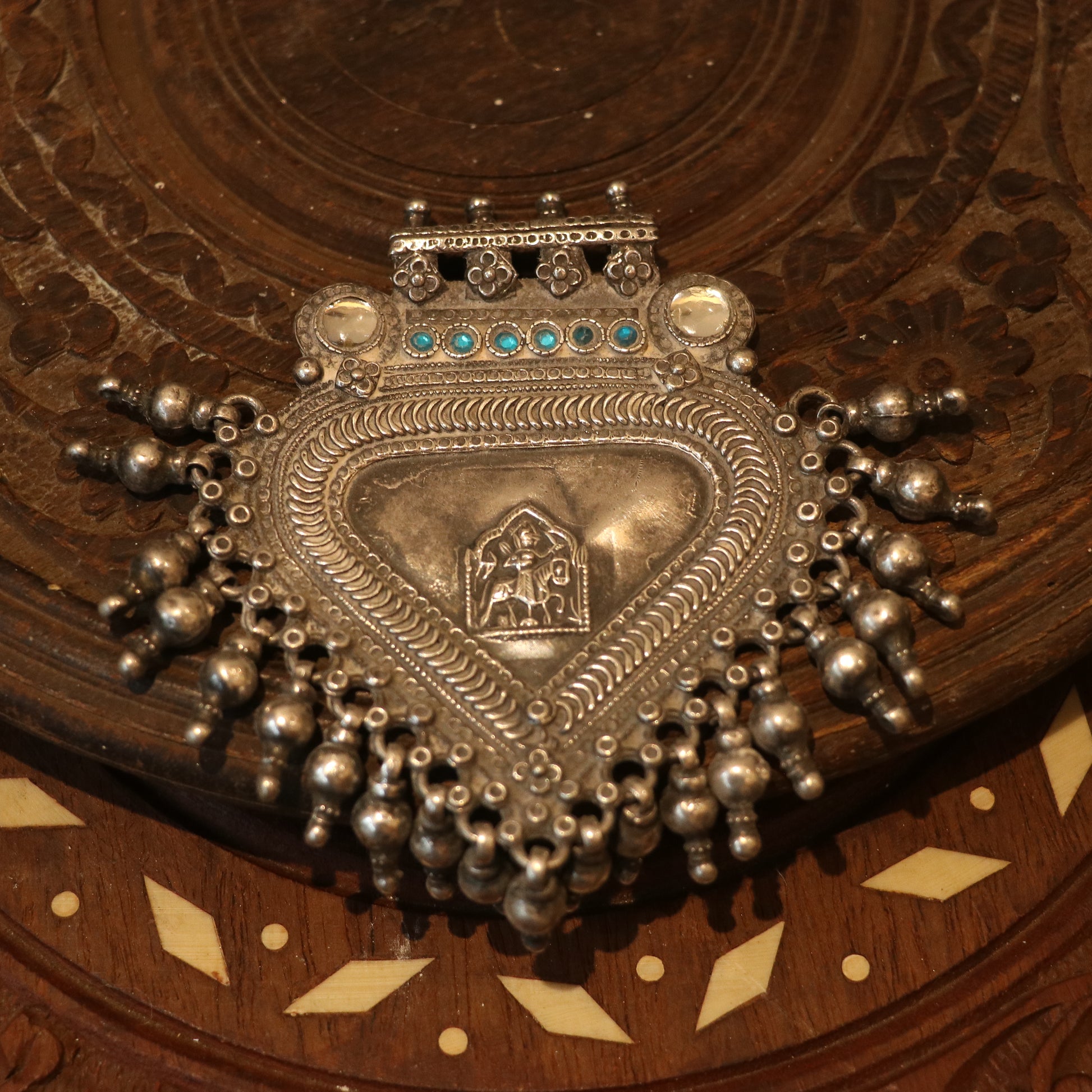 SILVER PENDANT WITH TRIBAL MOTIF , BLUE ACCENTS , AND HANGING BEEDS