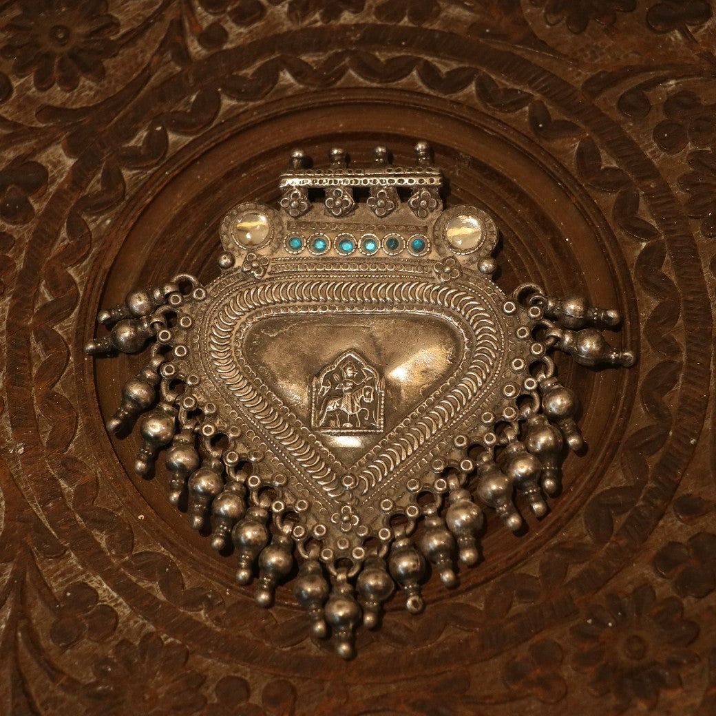 SILVER PENDANT WITH TRIBAL MOTIF , BLUE ACCENTS , AND HANGING BEEDS