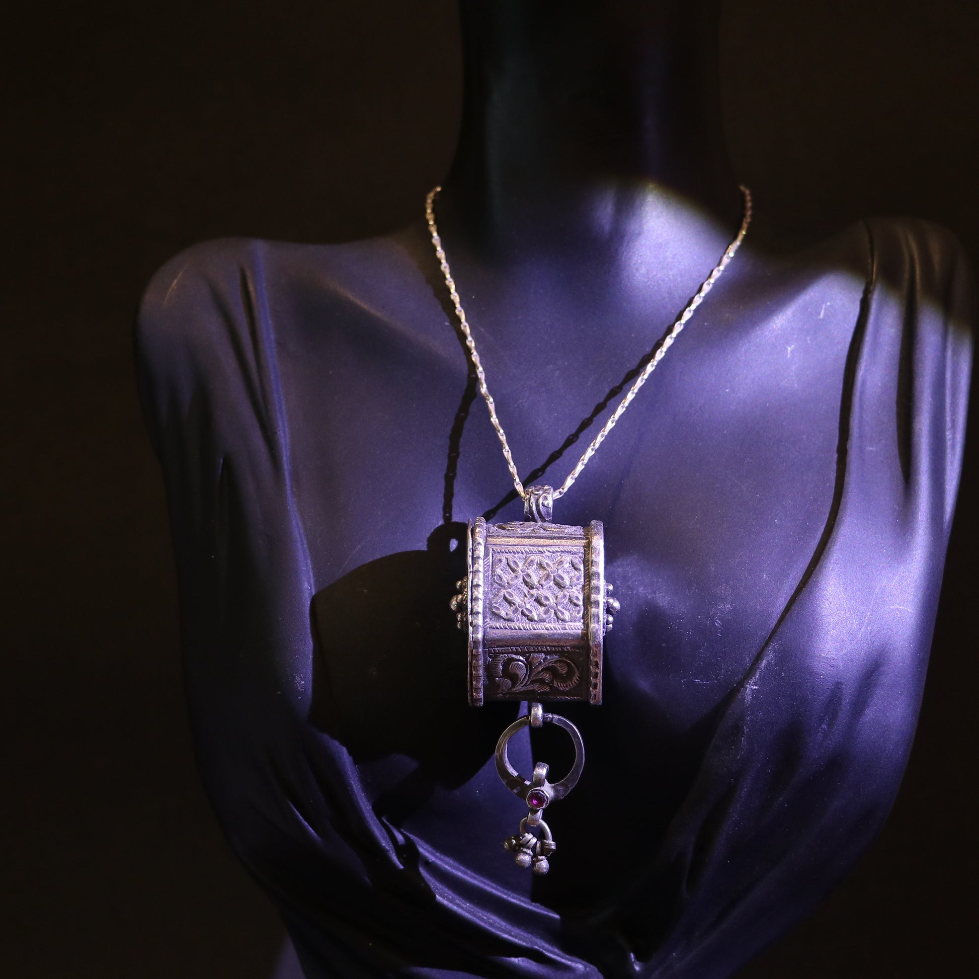 ANTIQUE SILVER AMULET WITH FLORAL ENGRAVINGS